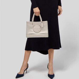 Coach Dempsey Carryall Tote in chalk pebble leather.